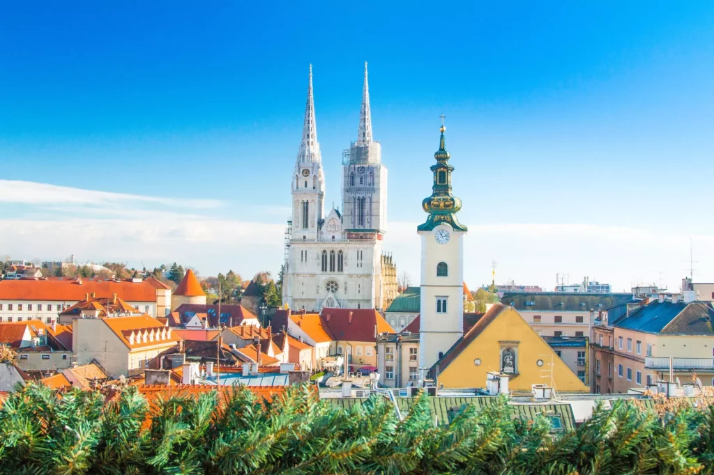 Croatian capital Zagreb, city skyline, catholic cathedral and red roofs in city center, view from Upper town. Christmas advent decoration.